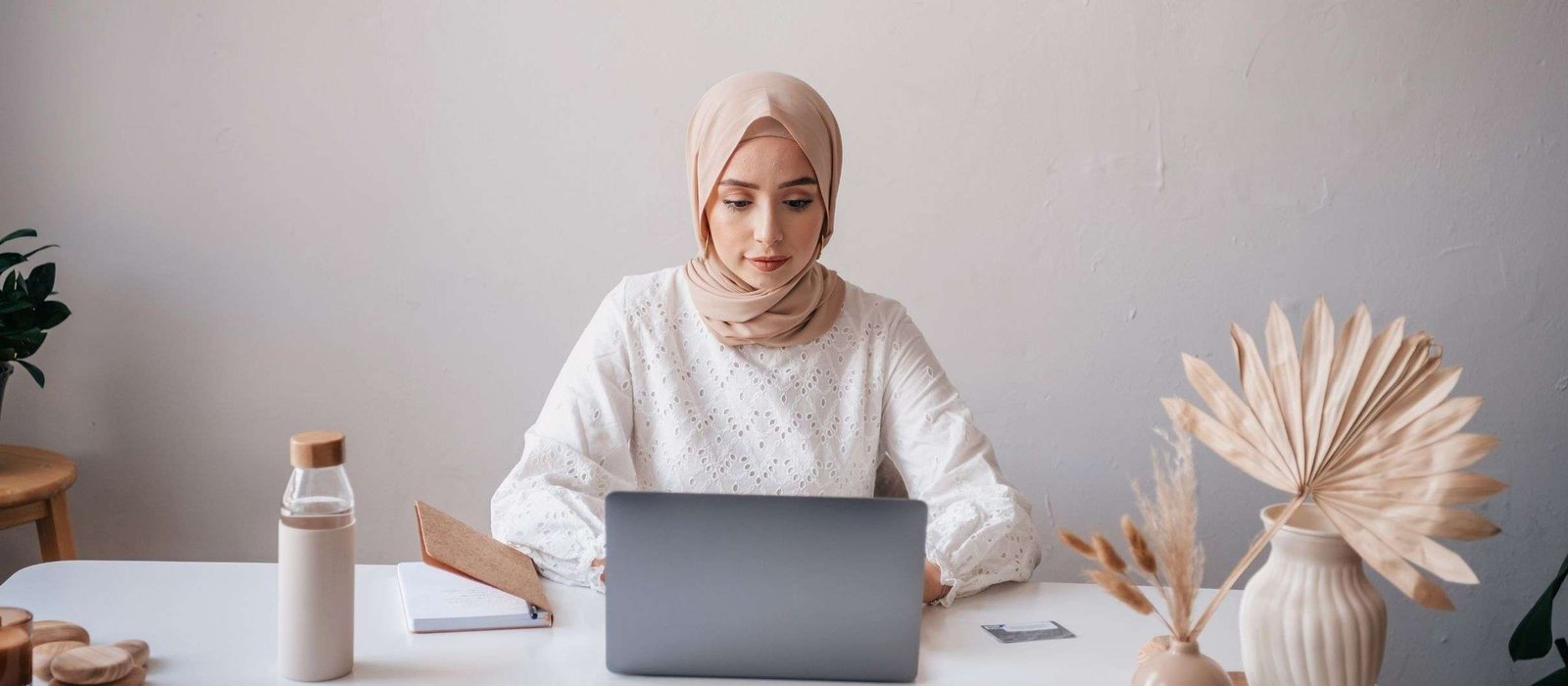 arabic Young woman in hijab using laptop to study Arabic Language Courses online