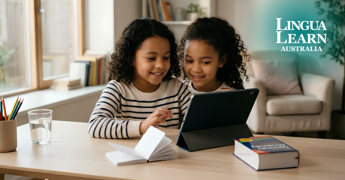 Two young children smiling while looking at a tablet during an online lesson as part of their CEFR levels for children program with Lingua Learn Australia.