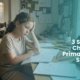 A young student looking tired while trying to do homework at her desk, highlighting 3 signs your child needs primary school support in Term 4 with Lingua Learn Australia.